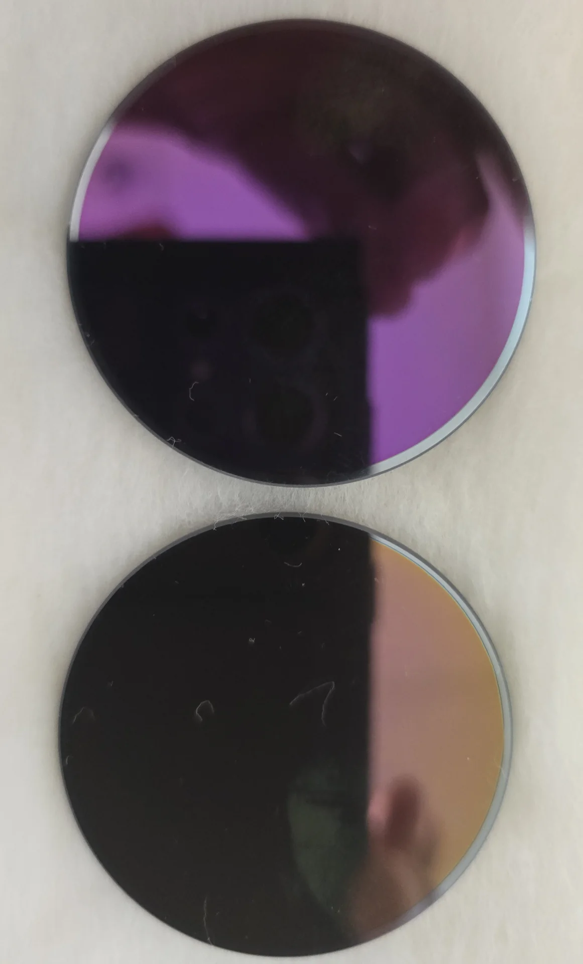 Two round Panasonic infrared filters with reflective surfaces