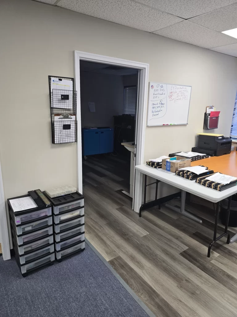 ProxDose staging laboratory with worktables, drawers and a doorway